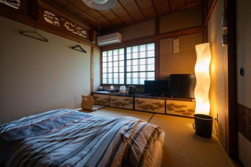 a bedroom with a bed and a large window at Chizu - Vacation STAY 83922v in Mitoyo