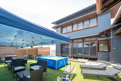 a patio with a pool table and chairs and a building at Chizu - Vacation STAY 83949v in Mitoyo