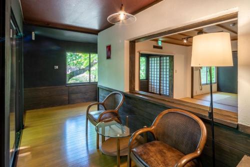 a living room with two chairs and a glass table at Mori no yadori Nasu bettei Maruyama - Vacation STAY 13190 in Nasu-yumoto