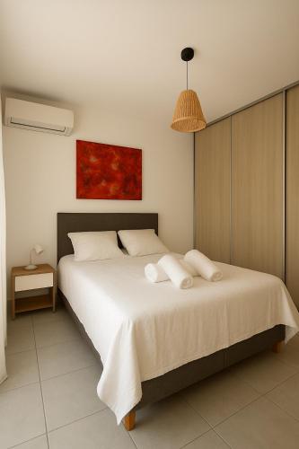 a bedroom with a bed with two towels on it at Résidence Arborea C4 corte in Corte