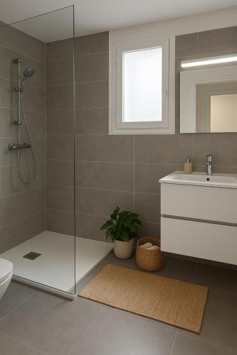 a bathroom with a shower and a toilet and a sink at Résidence Arborea C4 corte in Corte