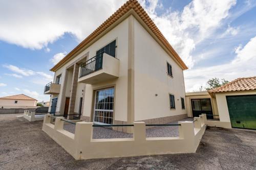 a villa with a view of a building at Simões Charm By HR Madeira in Vila Baleira