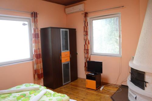 a bedroom with a bed and a tv in a room at Elegance on a Budget - Rooms for Rent in Sofia Center in Sofia