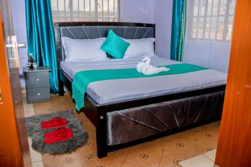 a bedroom with a bed with a stuffed animal on it at 1br 2br and 3br Klaire's apartments in Kisumu