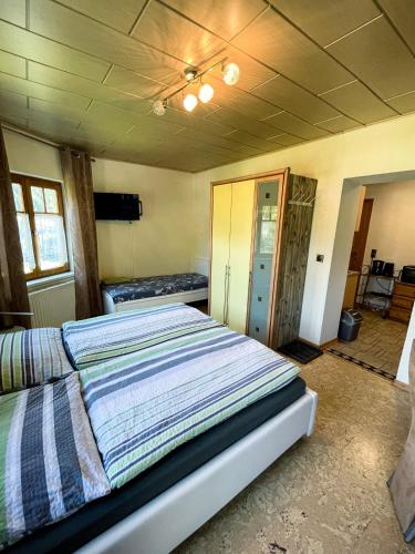 a bedroom with a bed with a striped comforter at Apartment Klapo in Bad Gastein