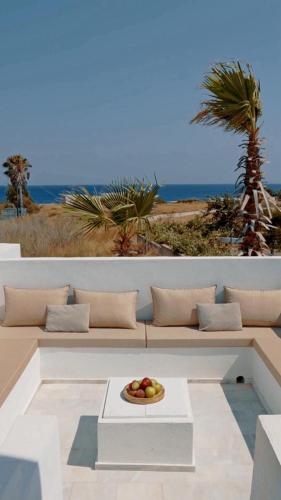 a bowl of fruit on a plate on a bench at Seadream - Luxury Villa - Pool & Sea View in Lachania