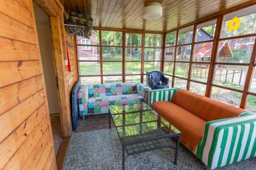 a living room with a couch and chairs in a cabin at Chata Vranov in Vranov nad Dyjí