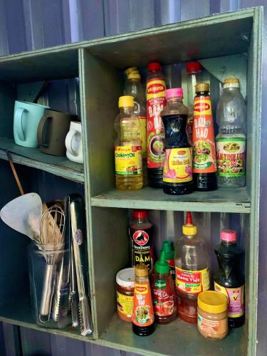 a cabinet filled with lots of condiments at Chill Door Homestay in Ấp Long Ðại