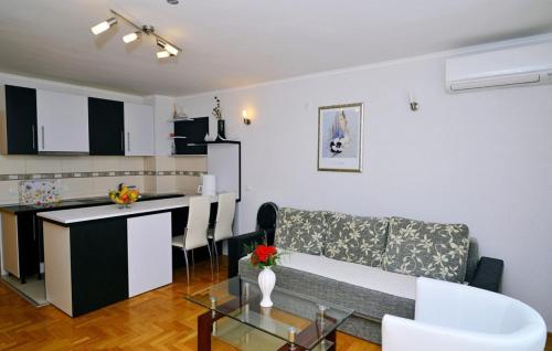 a living room and kitchen with a couch and a table at Apartman Zora 1 by Villas Guide in Mošćenice