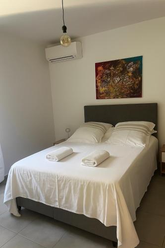 a bedroom with a bed with two towels on it at Résidence Arborea C3 Corte in Corte