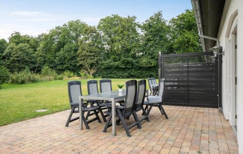 a table and chairs sitting on a patio at 3 Bedroom Nice Apartment In Nimtofte in Nimtofte