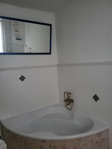 a bath tub in a bathroom with a mirror at Ferienwohnung Sieg in Mittelhof