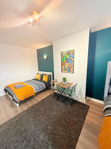 a bedroom with a bed and a table at 5 minutes to Wembley Rooms in London