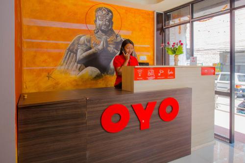 a woman standing at a counter in a store at OYO 260 Hotel Cultural Inn in Kathmandu