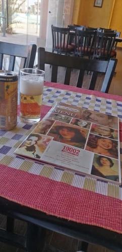 a table with a book and a glass of beer at Elegant Apartments & Aquapark - B&B- FREE WI-FI-Sharm El Sheikh in Sharm El Sheikh