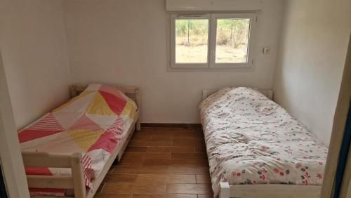 a small bedroom with a bed and a window at Maison au calme dans la Drôme in Saulce-sur-Rhône