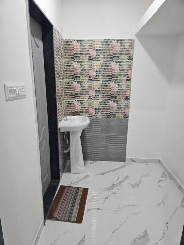 a white bathroom with a sink and a toilet at Azura Vista by Alt Acco in Pune