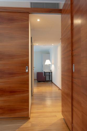 a large wooden door leading into a living room at Pakat Suites in Vienna