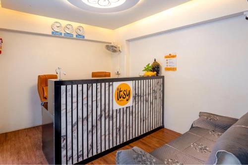 a living room with a fence and a couch at Itsy Hotels Metro in Pune