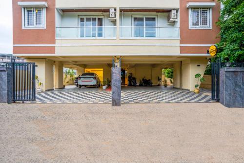 a house with a car parked in the garage at Itsy Hotels Metro in Pune