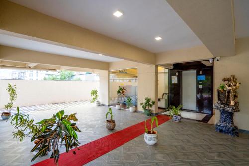 a lobby with potted plants and a red carpet at Itsy Hotels Metro in Pune