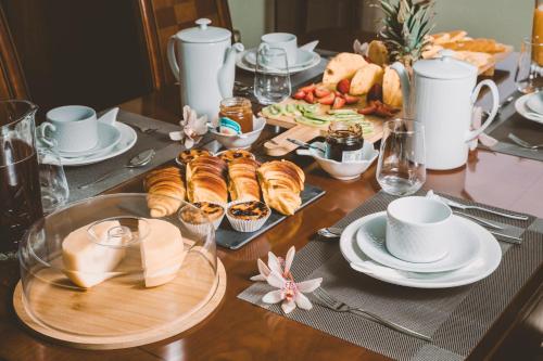 a table with pastries and cups and plates of food at House Douro Panorama Valley in Pinhão