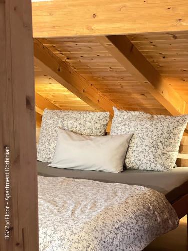 a bed in a room with a wooden ceiling at Ferienwohnung Barbara in Oberammergau