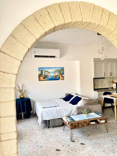 a living room with a bed and a table at Antonia's Apartments in Archangelos
