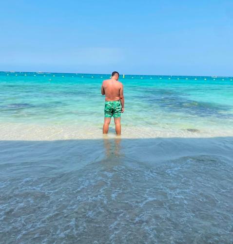 a man standing in the water on the beach at Sr Perú Baru in Polonia