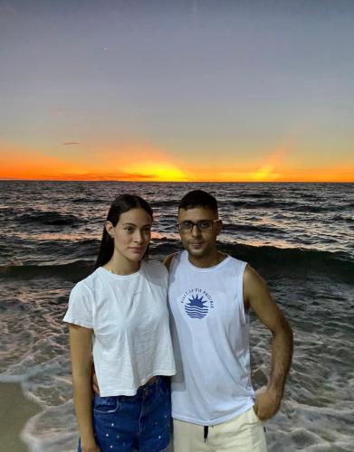 a man and a woman standing on the beach at Sr Perú Baru in Polonia