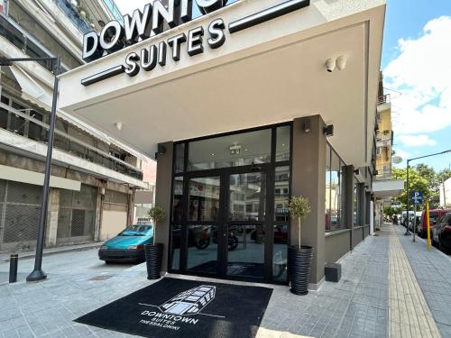 a store front with a sign on the sidewalk at Downtown Suites in Thessaloniki