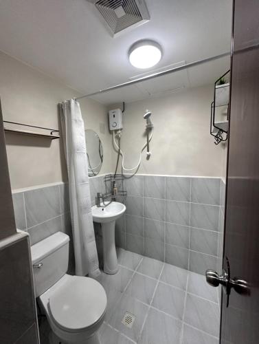 a bathroom with a toilet and a sink at J&A Arcadia in Lapu Lapu City