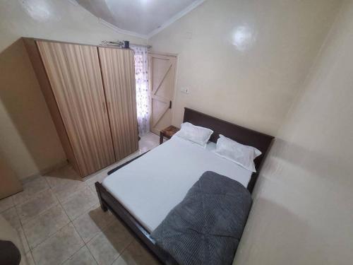 a small bedroom with a bed in a room at Two Bedroom Guest House in Nairobi