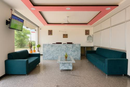 a living room with two blue couches and a table at Bp lake view in Udaipur