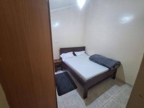 a small bedroom with a small bed in a room at Two Bedroom Guest House in Nairobi
