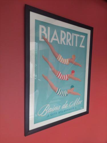 a framed picture of people swimming in the water at The Vicarage in Mirissa