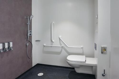 a bathroom with a toilet and a shower stall at OSKO Hôtel Toulouse Aéroport in Blagnac