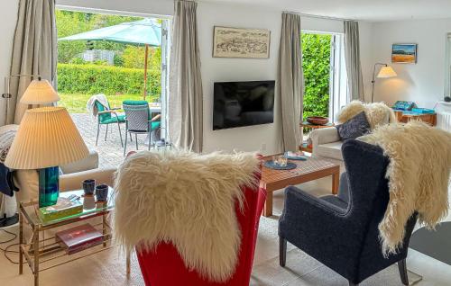 a living room with two chairs and a table with a couch at Four Bedroom Nice Home In Gilleleje in Gilleleje