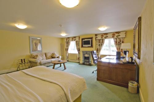 a bedroom with a bed and a living room at Best Western Premier Doncaster Mount Pleasant Hotel in Doncaster