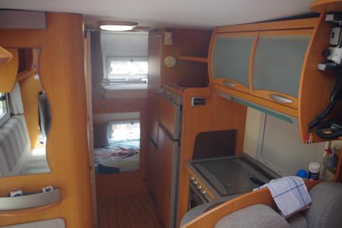 an interior view of a small room with a laptop at CHEZ MITCH EN CAMPING CAR et grand espace extérieur in Caillavet