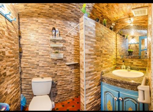 a bathroom with a toilet and a sink at riad la citadelle in El Jadida
