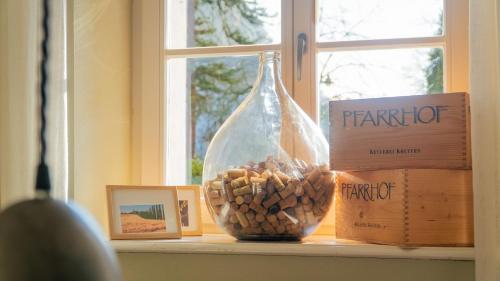 a window sill with a bottle and a bowl of nuts at Albergo-Toscana in Bad Schandau