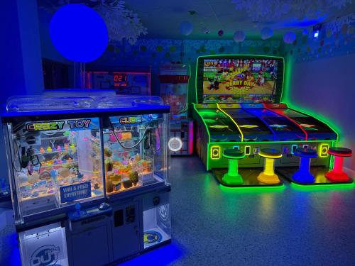 two arcade games in a room with a video game at Forest beach Shorefield Park in Lymington