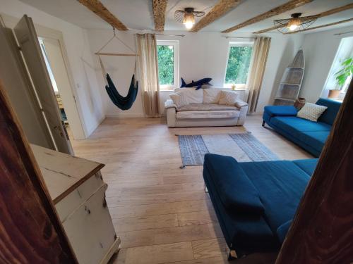 a living room with a couch and a blue couch at Haus Wiese & Lagune in Ettenheim
