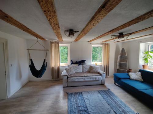 a living room with a couch and two bats on the ceiling at Haus Wiese & Lagune in Ettenheim