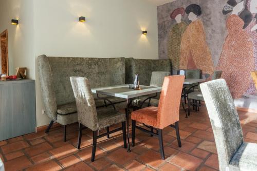 a dining room with tables and chairs and a mural at Albergo-Toscana in Bad Schandau