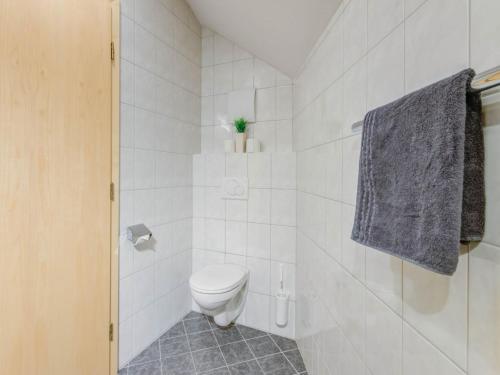 a white bathroom with a toilet and a towel at Inviting Apartment in Fiss in the Mountains in Fiss