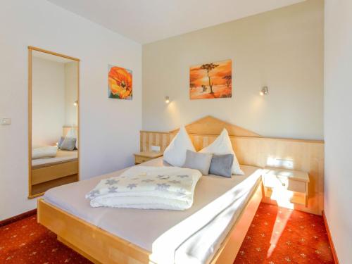 a bedroom with a large bed with a mirror at Inviting Apartment in Fiss in the Mountains in Fiss