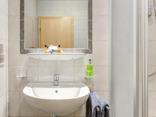 a bathroom with a white sink and a mirror at Inviting Apartment in Fiss in the Mountains in Fiss