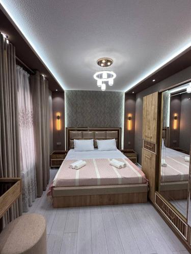 a bedroom with a large bed and a mirror at Heart of Samarkand, main center in Samarkand